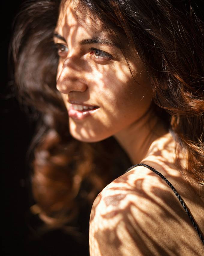 Portrait of Angelica in dappled sunlight, looking off camera